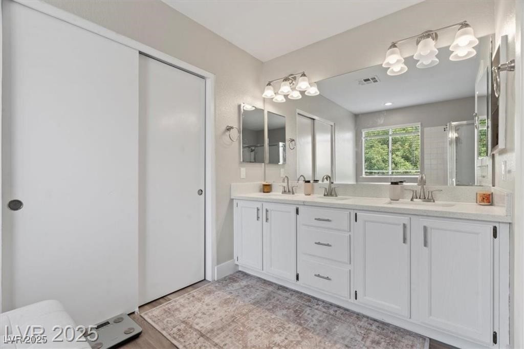 9416 Rolling Ridge Lane Las Vegas, NV 89134 - Photo 23 of 34 Bathroom featuring double vanity and a shower with door