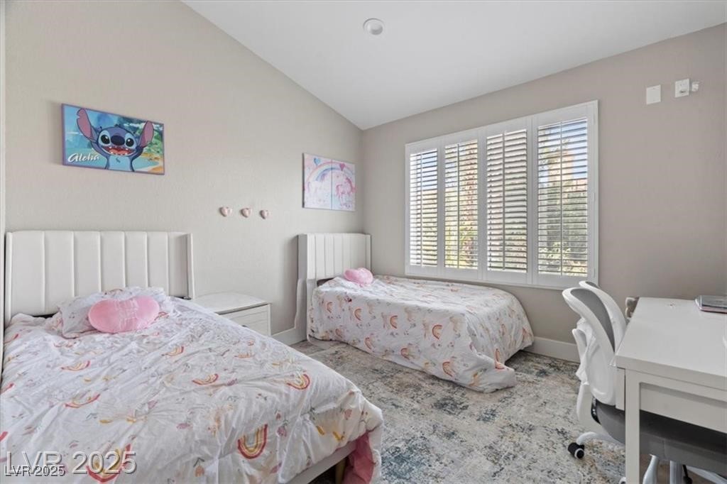 9416 Rolling Ridge Lane Las Vegas, NV 89134 - Photo 25 of 34 Bedroom with lofted ceiling and baseboards