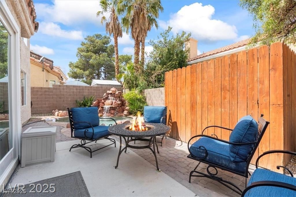 9416 Rolling Ridge Lane Las Vegas, NV 89134 - Photo 31 of 34 Fenced backyard featuring an outdoor fire pit and a patio area
