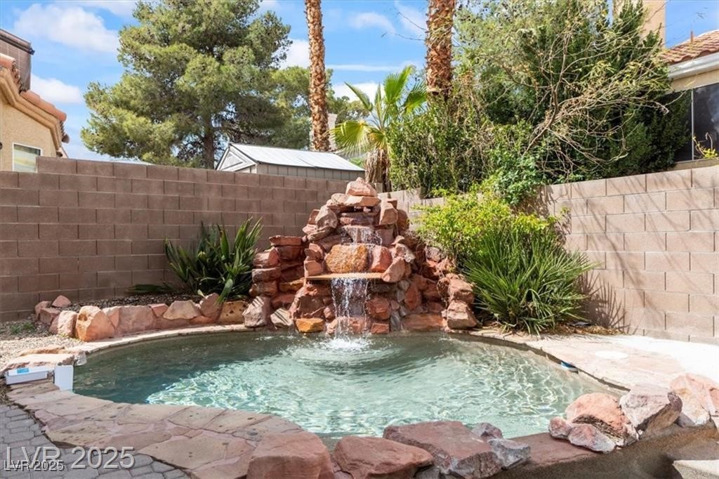 9416 Rolling Ridge Lane Las Vegas, NV 89134 - Photo 32 of 34 View of pool with a fenced backyard and a patio area