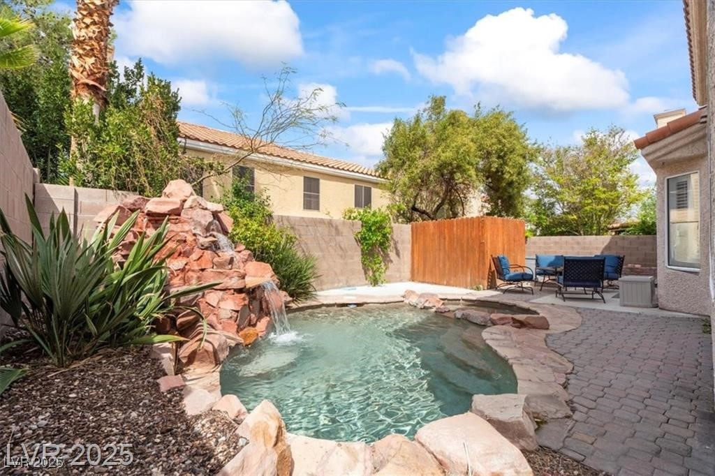 9416 Rolling Ridge Lane Las Vegas, NV 89134 - Photo 33 of 34 View of swimming pool featuring a fenced backyard and a patio area