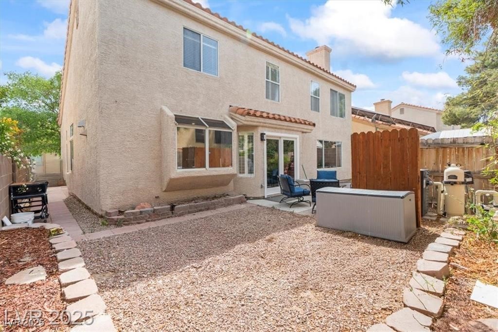 9416 Rolling Ridge Lane Las Vegas, NV 89134 - Photo 34 of 34 Rear view of property with a chimney, stucco siding, a patio area, and a tiled roof