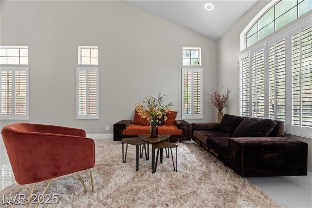 9416 Rolling Ridge Lane Las Vegas, NV 89134 - Photo 8 of 34 Living room with high vaulted ceiling and tile patterned floors
