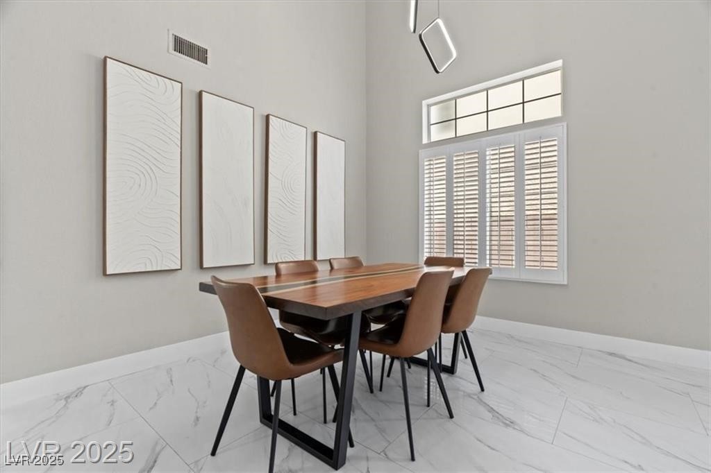 9416 Rolling Ridge Lane Las Vegas, NV 89134 - Photo 9 of 34 Dining room with a towering ceiling and light marble finish flooring