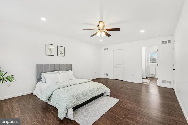a bedroom with a large bed and a chandelier