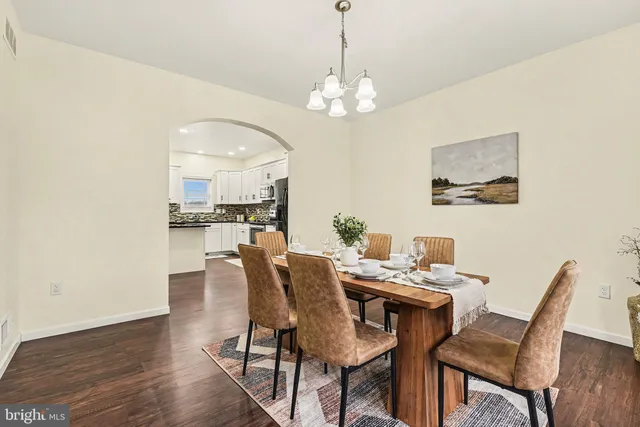 a view of a dining room with furniture wooden floor and a chandelier