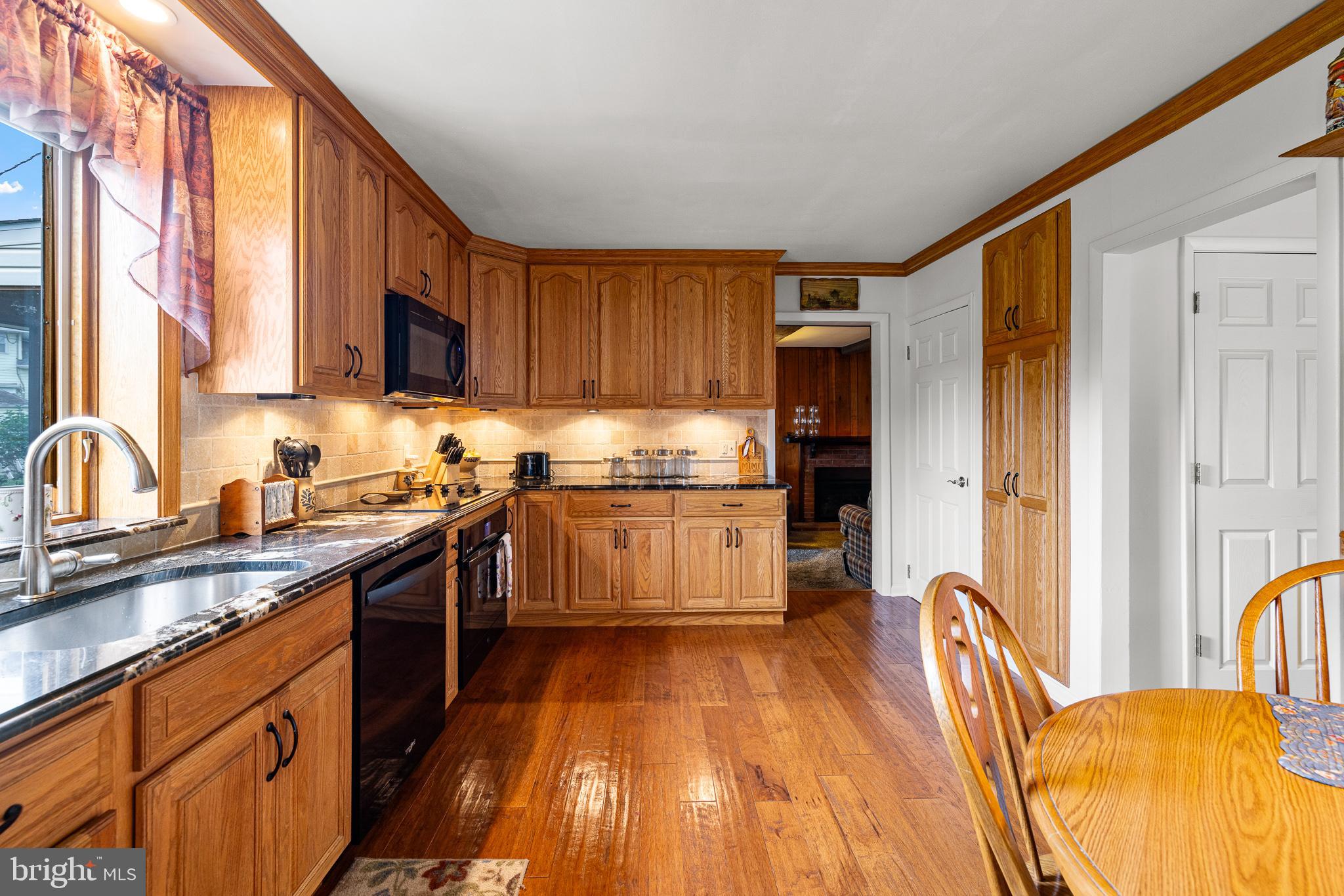 18 Whitfield Road Newark, DE 19711 - Photo 19 of 27 a kitchen with granite countertop wooden floors stainless steel appliances and window