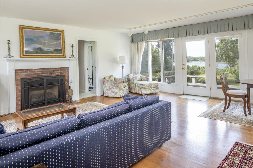 22 Jack Knife Point Road Orleans, MA 02653 - Photo 31 of 37 a living room with furniture and a fireplace