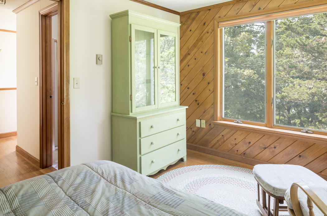 22 Jack Knife Point Road Orleans, MA 02653 - Photo 36 of 37 a bedroom with a bed and a dresser next to a window