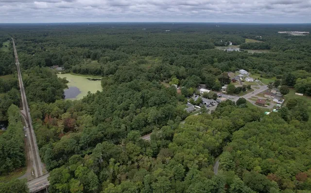 an aerial view of residential houses with outdoor and green space