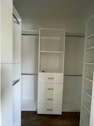 a view of storage and utility room with refrigerator
