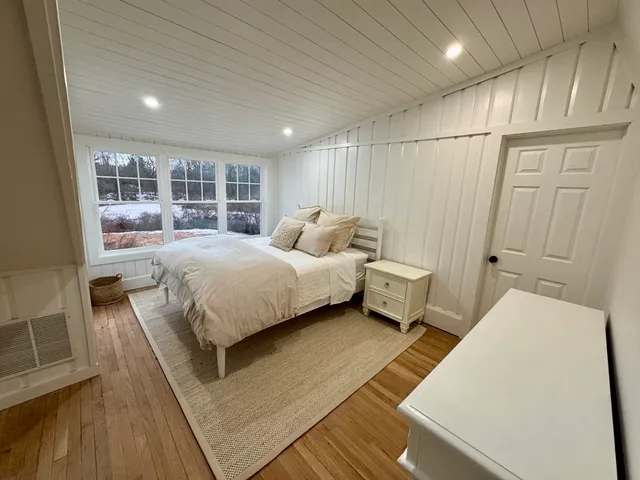 a bedroom with a bed and window