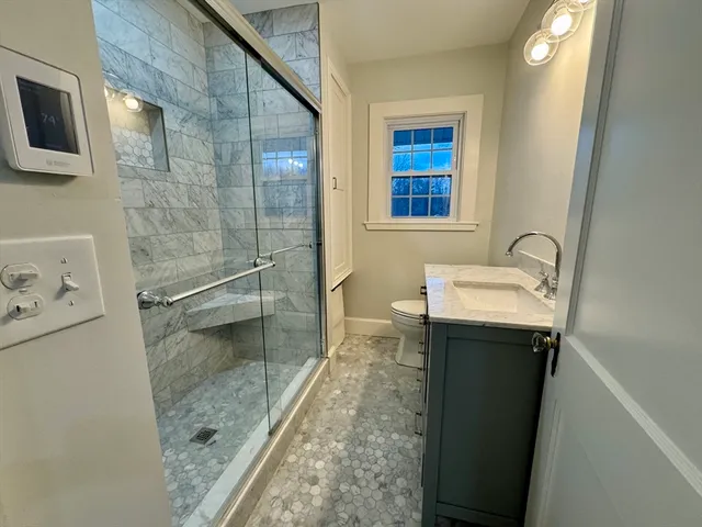 a bathroom with a sink a mirror and shower