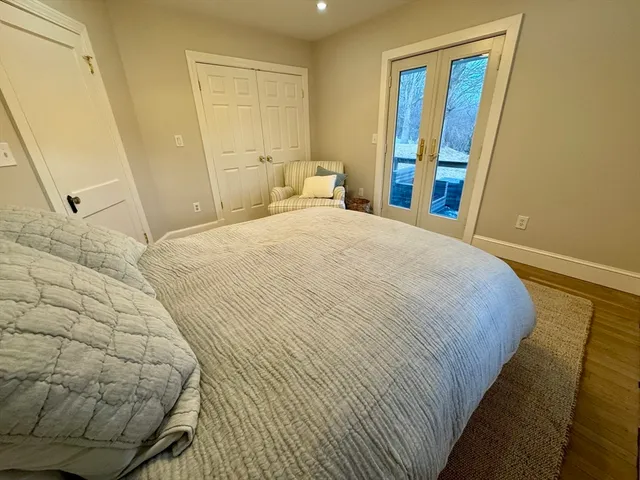 a bedroom with a bed and a mirror