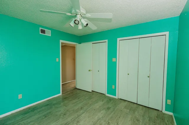 a view of an empty room with a fan