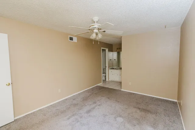 a view of an empty room with a fan