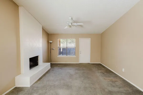 a big room with windows and fireplace