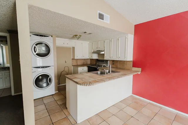 a view of a kitchen with washer and dryer