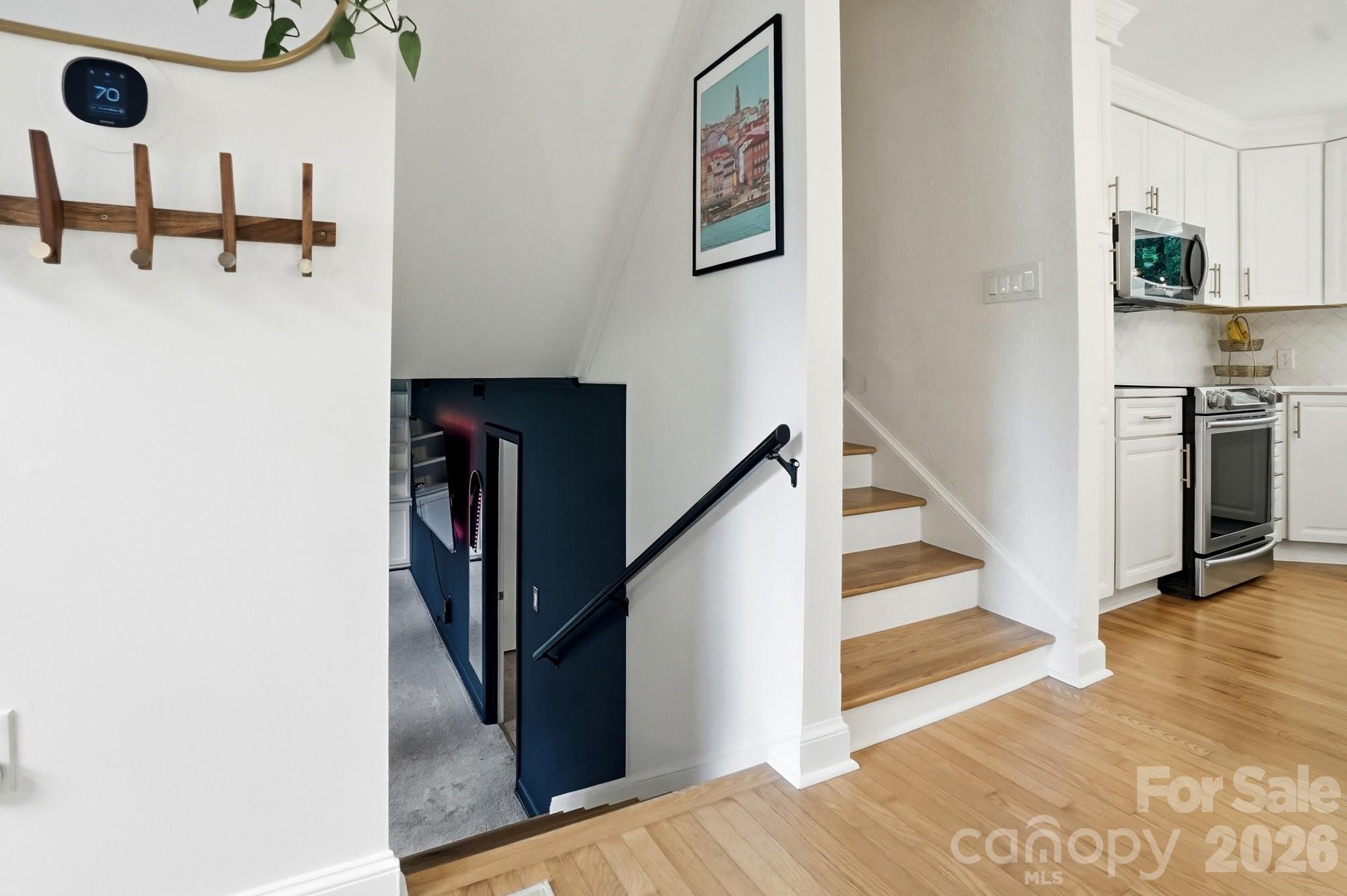 824 Riverwood Road Charlotte, NC 28270 - Photo 19 of 37 a view of a hallway with an entryway and wooden floor