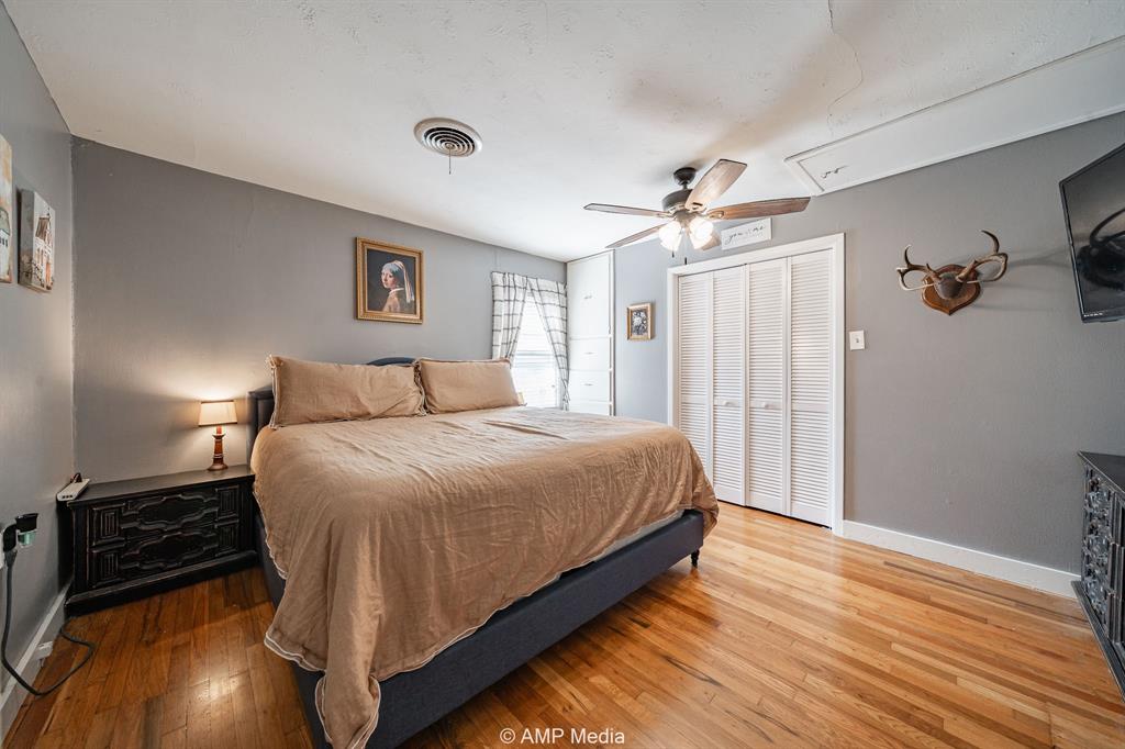 1309 Hudson Road Stamford, TX 79553 - Photo 17 of 35 a bedroom with a bed and a ceiling fan
