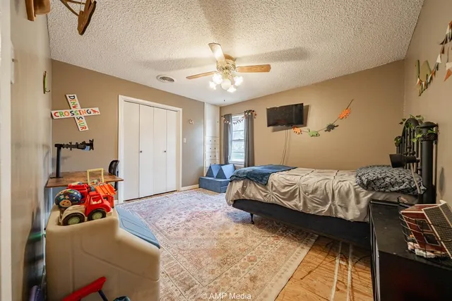 a bedroom with a bed and a chandelier