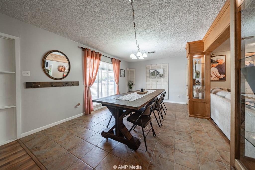 1309 Hudson Road Stamford, TX 79553 - Photo 5 of 35 a dining room with furniture a chandelier and wooden floor