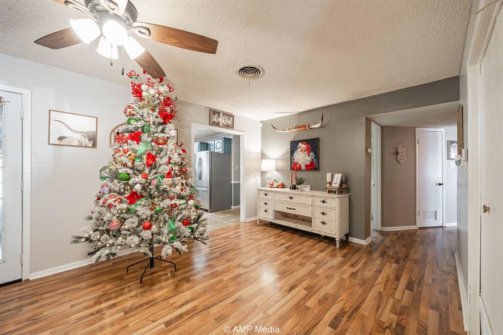 1309 Hudson Road Stamford, TX 79553 - Photo 9 of 35 a living room with furniture and a chandelier