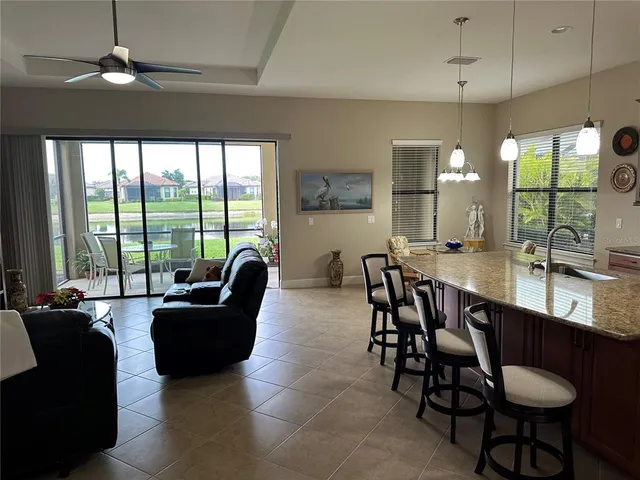 a dining room with furniture a chandelier and window