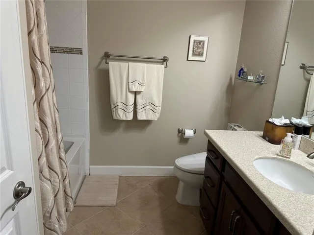 a bathroom with a sink toilet and a mirror