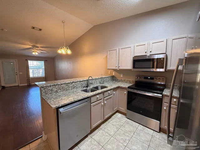 a kitchen with a stove and a microwave