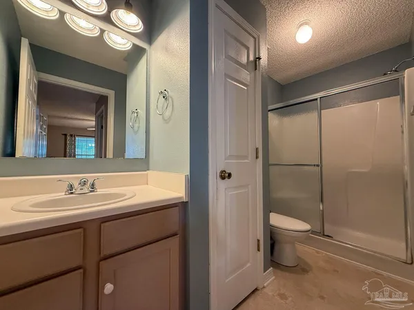 a bathroom with a double vanity sink toilet and shower