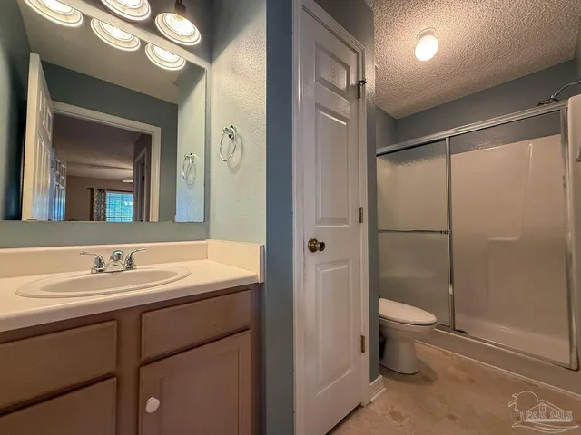 a bathroom with a double vanity sink toilet and shower