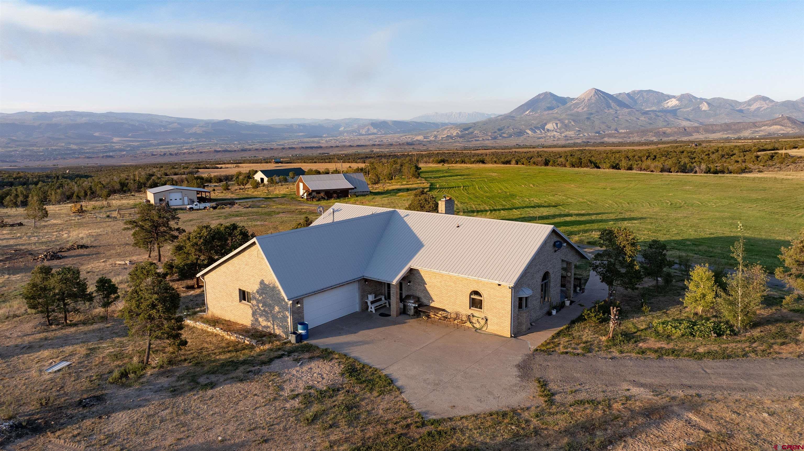 an aerial view of a house with a lake view