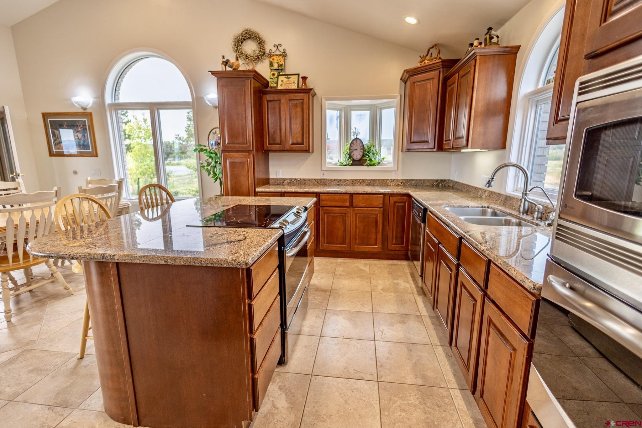 1253 3350th Road Crawford, CO 81415 - Photo 16 of 41 a kitchen with stainless steel appliances granite countertop a sink counter space cabinets and a window