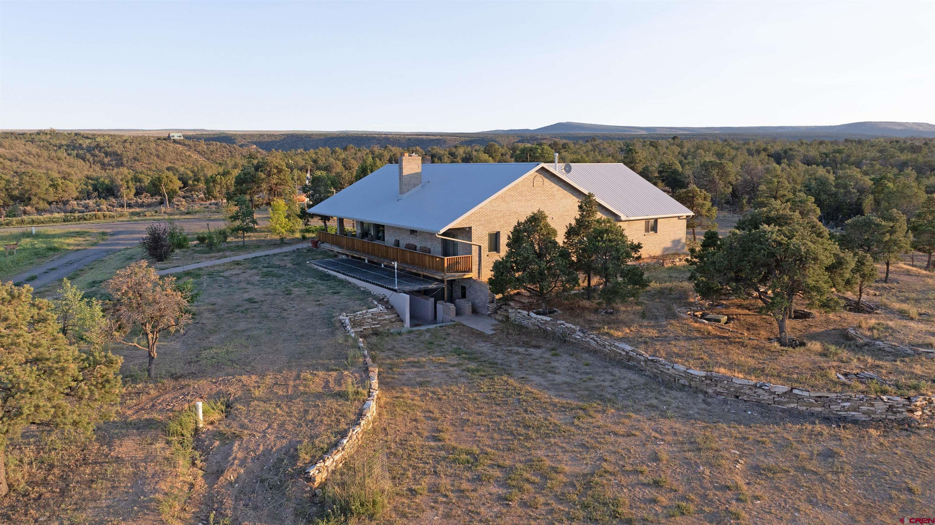 1253 3350th Road Crawford, CO 81415 - Photo 2 of 41 an aerial view of a house with a yard and wooden fence