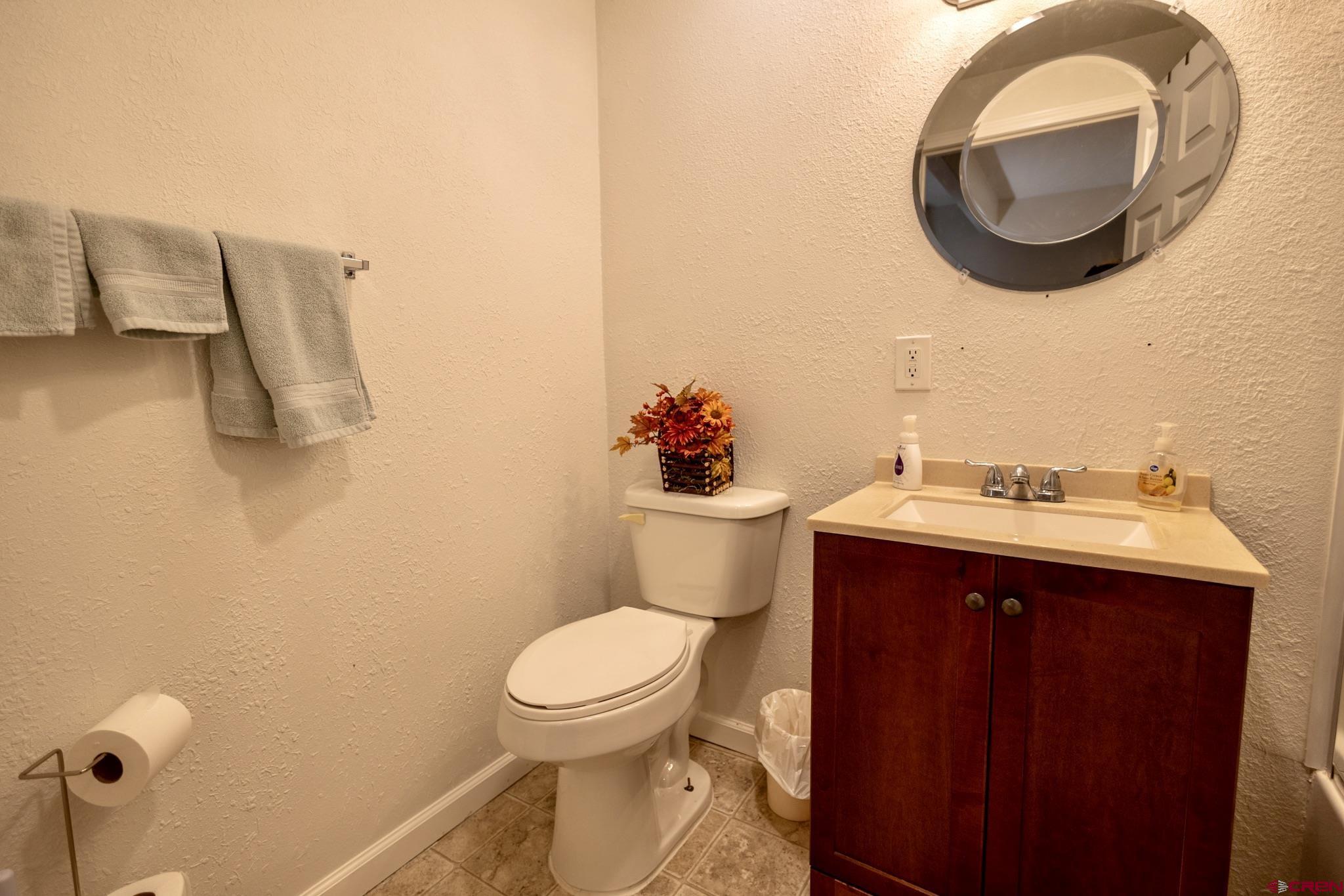 1253 3350th Road Crawford, CO 81415 - Photo 25 of 41 a bathroom with a sink mirror vanity and toilet