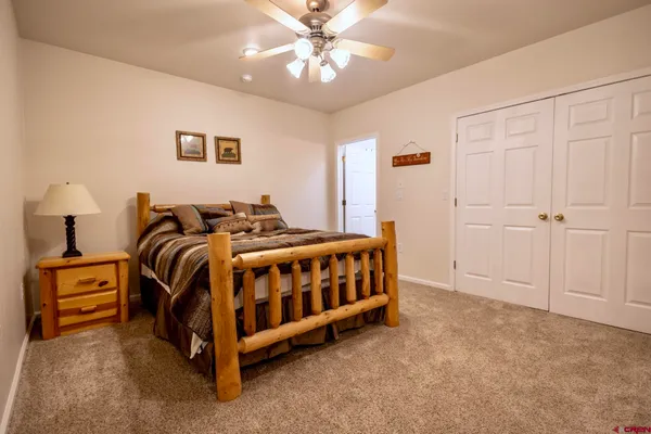 a bedroom with a bed next to a window
