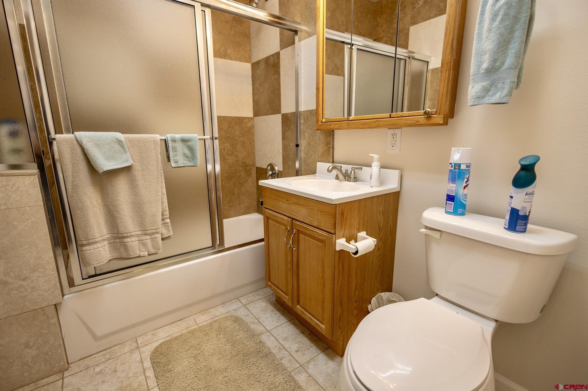 1253 3350th Road Crawford, CO 81415 - Photo 27 of 41 a white toilet sitting next to a bathroom sink