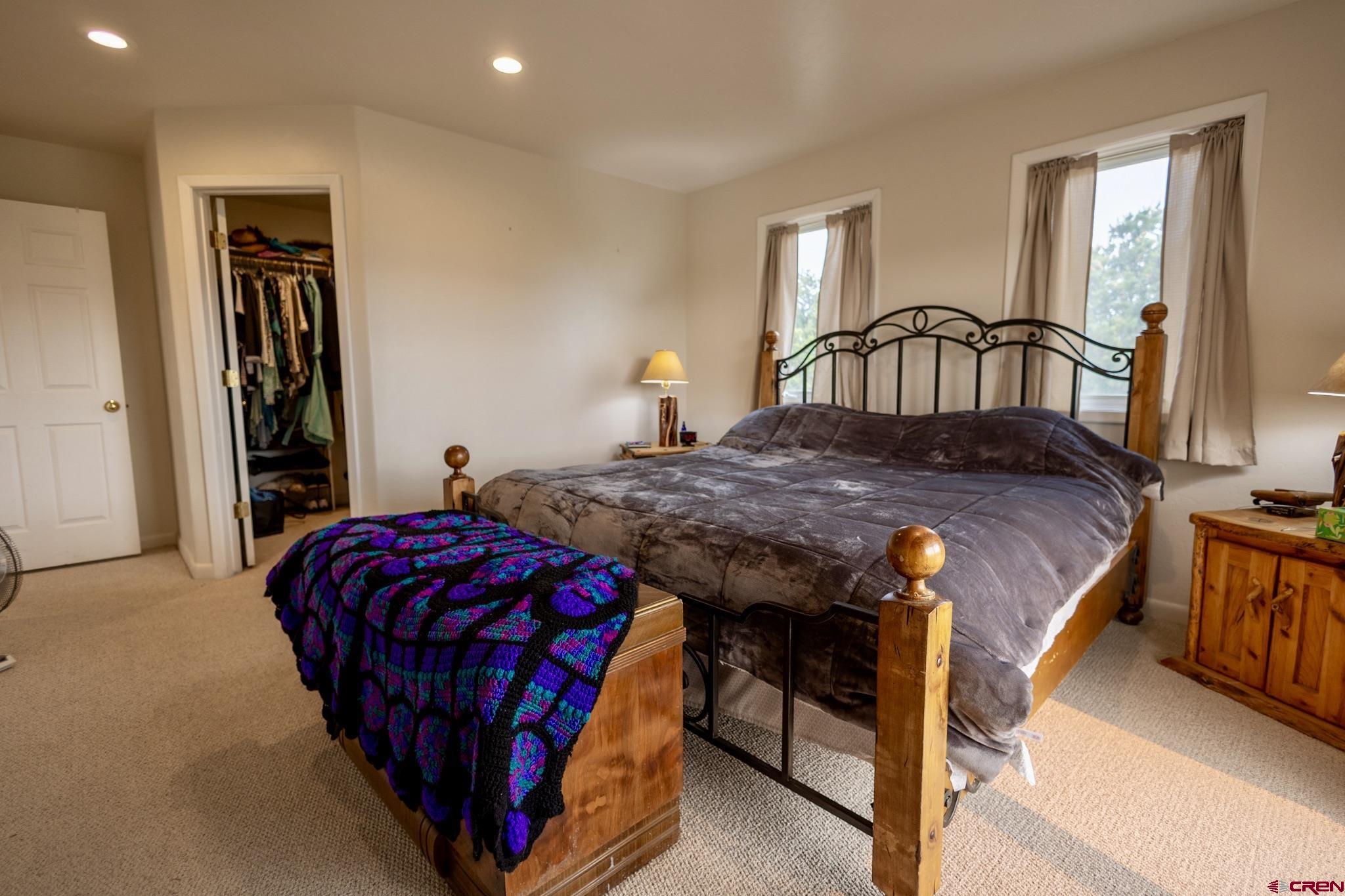 1253 3350th Road Crawford, CO 81415 - Photo 29 of 41 a bedroom with a bed next to a window