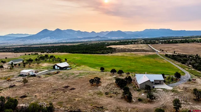 a bathroom with a granite countertop sink a mirror and shower