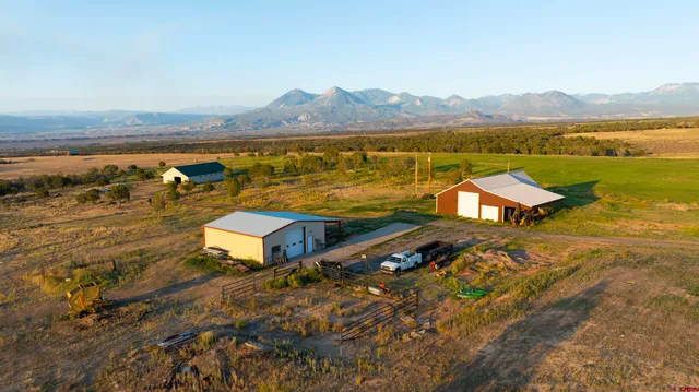 an aerial view of a house with a yard