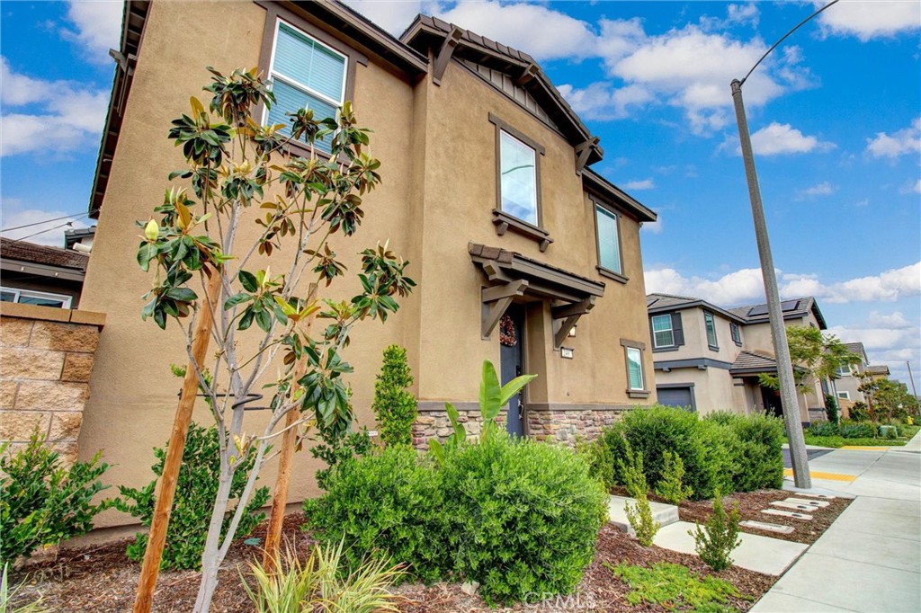 2497 Gunner Ridge Way Rialto, CA 92377 - Photo 1 of 49 a front view of a house with a garden