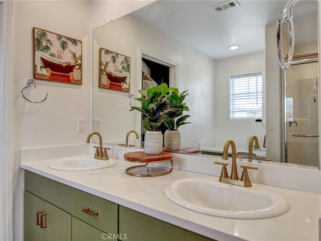 2497 Gunner Ridge Way Rialto, CA 92377 - Photo 22 of 49 a bathroom with a sink and a mirror