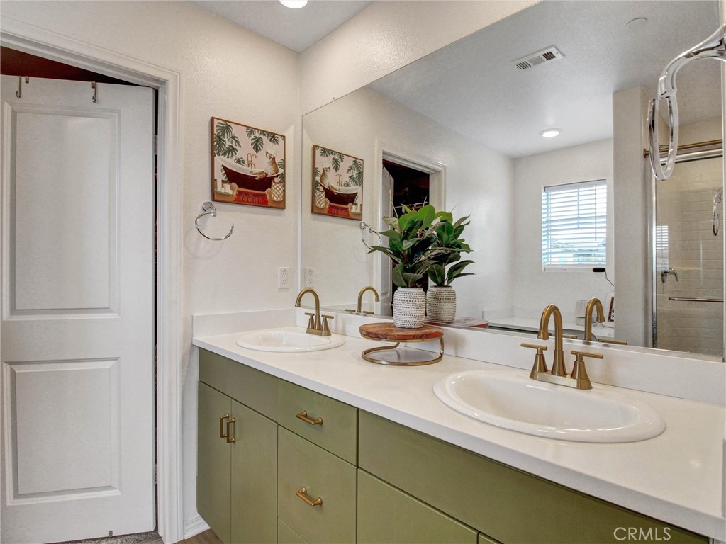 2497 Gunner Ridge Way Rialto, CA 92377 - Photo 24 of 49 a bathroom with a sink and a mirror