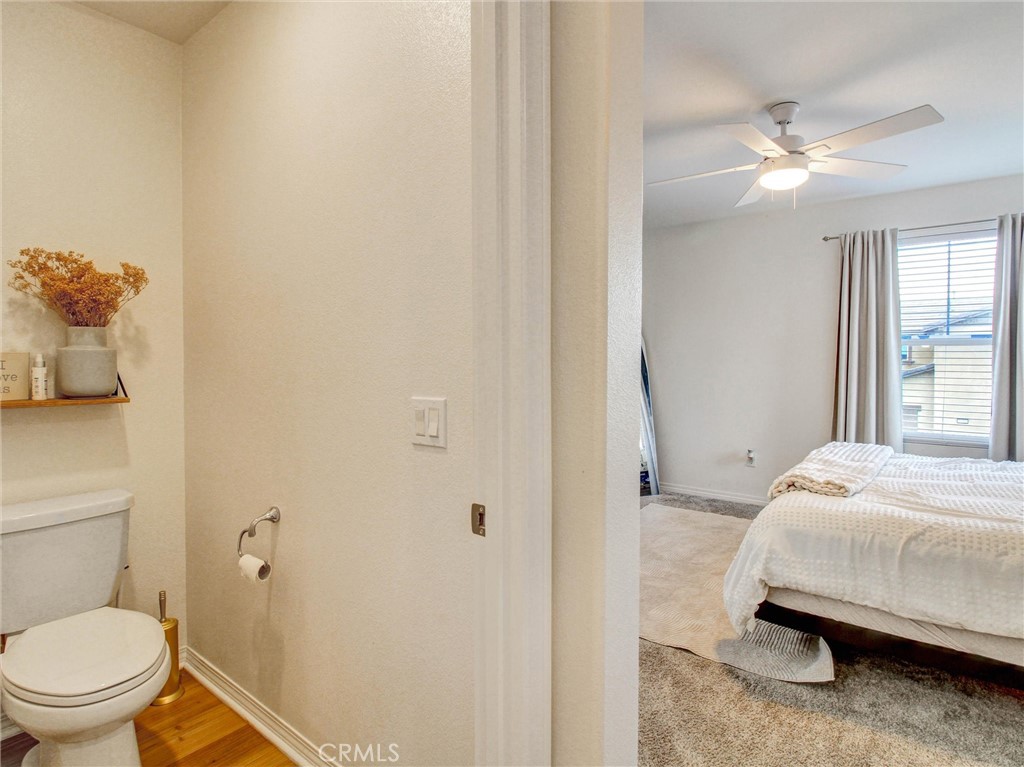 2497 Gunner Ridge Way Rialto, CA 92377 - Photo 26 of 49 a bedroom with a bed and a chandelier