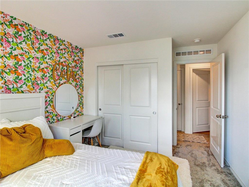 2497 Gunner Ridge Way Rialto, CA 92377 - Photo 29 of 49 a bedroom with a bed and a painting on the wall