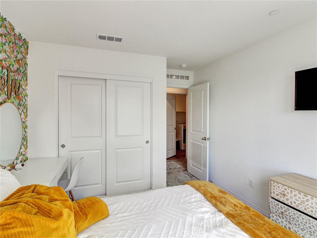 2497 Gunner Ridge Way Rialto, CA 92377 - Photo 30 of 49 a bedroom with a bed and a flat screen tv
