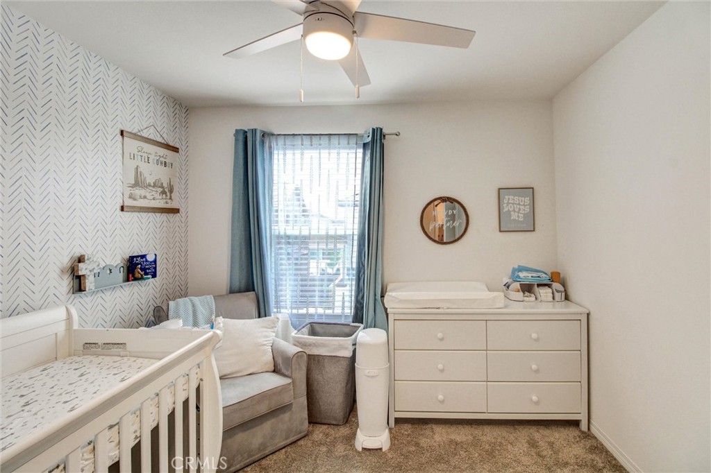 2497 Gunner Ridge Way Rialto, CA 92377 - Photo 34 of 49 a bedroom with a bed and a window