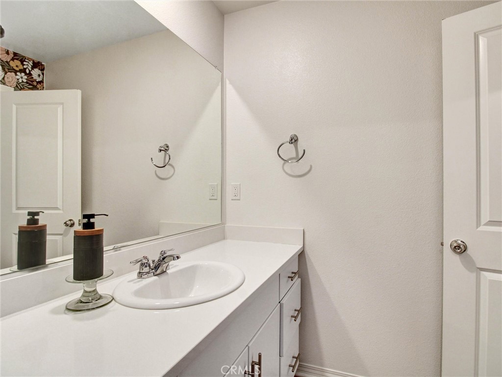 2497 Gunner Ridge Way Rialto, CA 92377 - Photo 36 of 49 a bathroom with a sink and a mirror