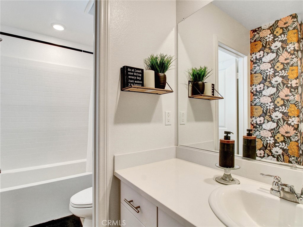 2497 Gunner Ridge Way Rialto, CA 92377 - Photo 37 of 49 a bathroom with a sink and a mirror
